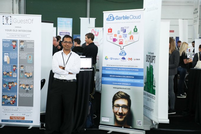Person stands in front of GarbleCloud exhibit table in the Expo Hall at TechCrunch Disrupt 2017 in SF