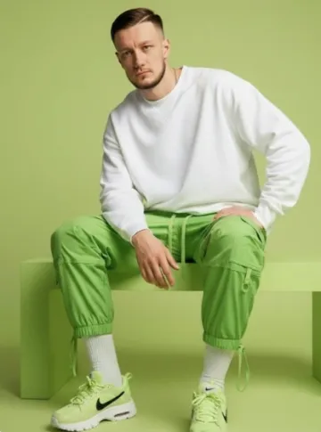 Main model (use image input with the face 100% accurate).

Wearing: 
[detailed clothing description - pieces, color scheme, style, layers, fabrics].

Paired with footwear: 
[type and details of shoes; include relevant accessories like socks, hats, bags, jewelry, etc.].

Setting: 
studio backdrop in soft [describe color/tone/texture - e.g., pastel, urban, concrete, natural, saturated].

Lighting: 
soft cinematic studio lighting

Style: 
[define style - for example: fashion editorial, streetwear, minimalism, preppy, futuristic, luxury, sporty, etc.].

Composition: 
model [describe pose - seated/standing/reclined, relaxed/confident/youthful] on [describe object if relevant - bench, chair, wall], with [accessories/pose details - e.g., accessories visible, hands in pocket, dramatic posture].